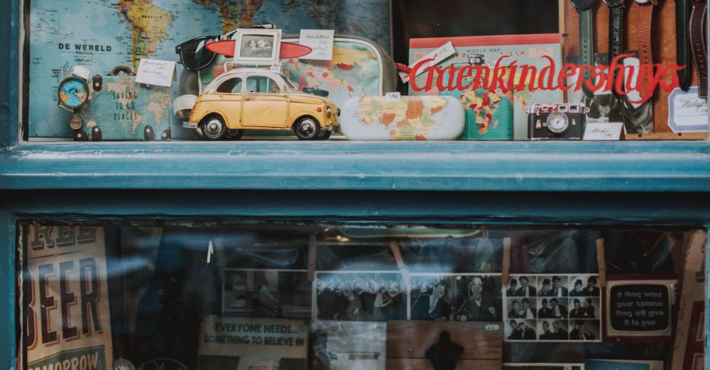 Personalized Gifts - Charming window showcasing vintage maps, toy cars, and memorabilia in Brussels.