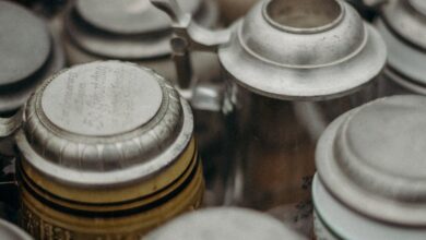 Craft Beer Markets - Close-up of assorted vintage beer steins at a flea market, showcasing ornate details.