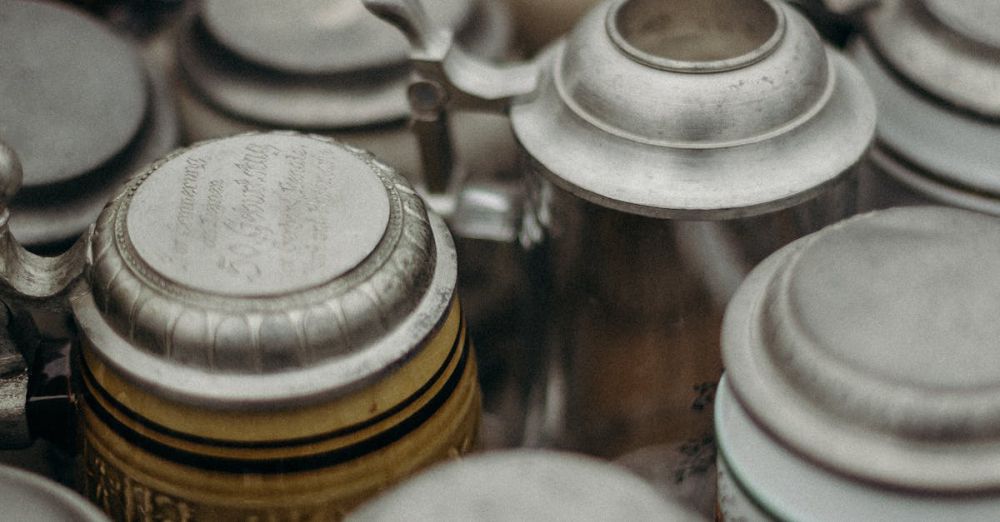 Craft Beer Markets - Close-up of assorted vintage beer steins at a flea market, showcasing ornate details.