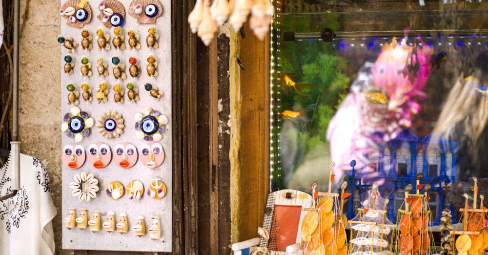 Unique Gifts Markets - Colorful seaside market stall displaying seashell souvenirs and decorative items.