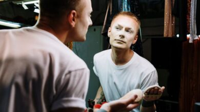 Makeup - Portrait of a drag artist in a dressing room applying makeup, embodying transformation and self-expression.