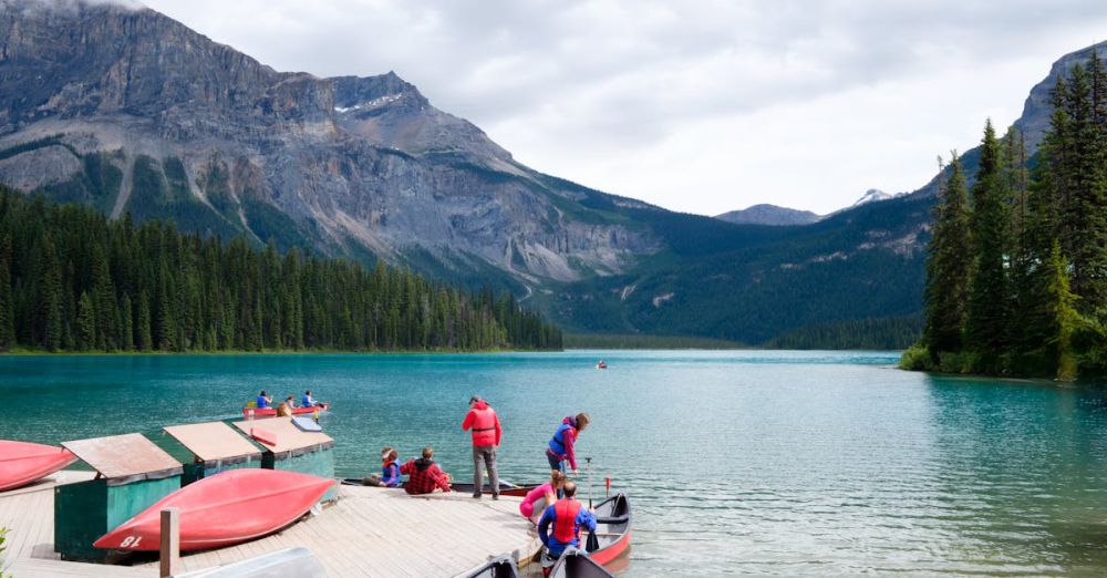 Experienced Paddlers - Group enjoying kayaking in a picturesque mountain lake surrounded by lush forests.