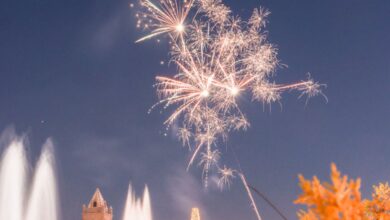 Outdoor Winter Festivals - Vibrant fireworks light up the night sky above a festive town square celebrating the holiday season.