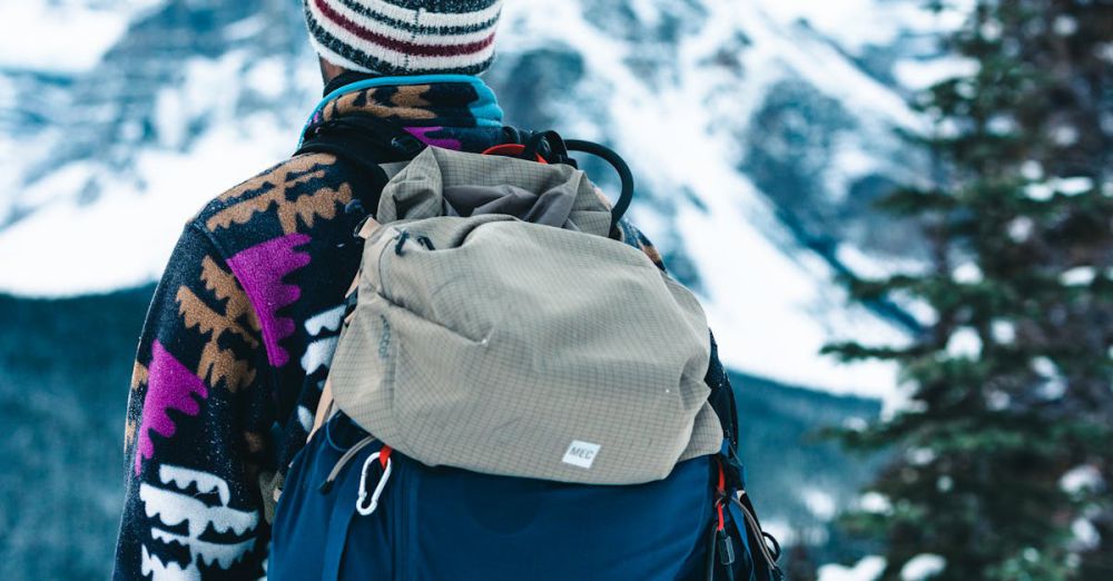 Snowshoeing Winter Festivals - A hiker stands with winter gear, enjoying a scenic mountain view in Banff National Park.