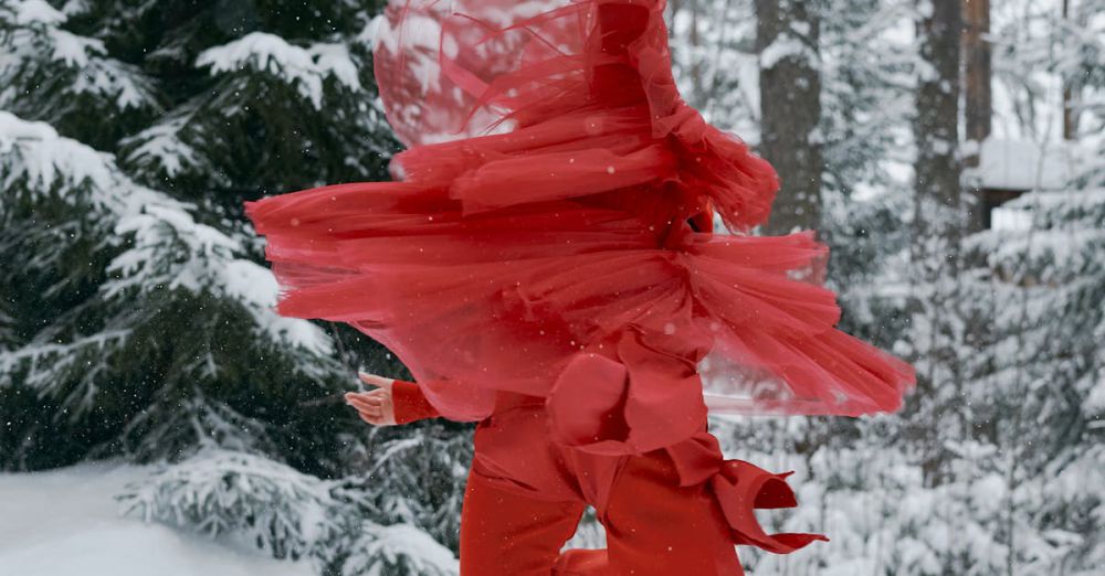 Ice Skating Festivals - Dynamic image of a figure skater in red twirling on ice amidst a snowy forest. Captivating winter scene.