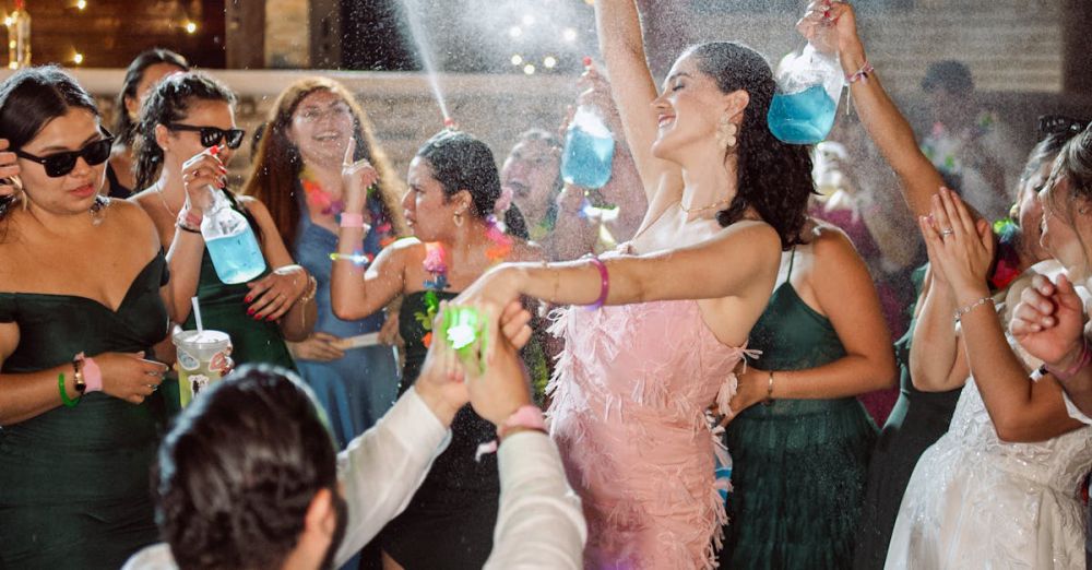 Music & Dance Festivals - Lively wedding party with guests celebrating under string lights at night.