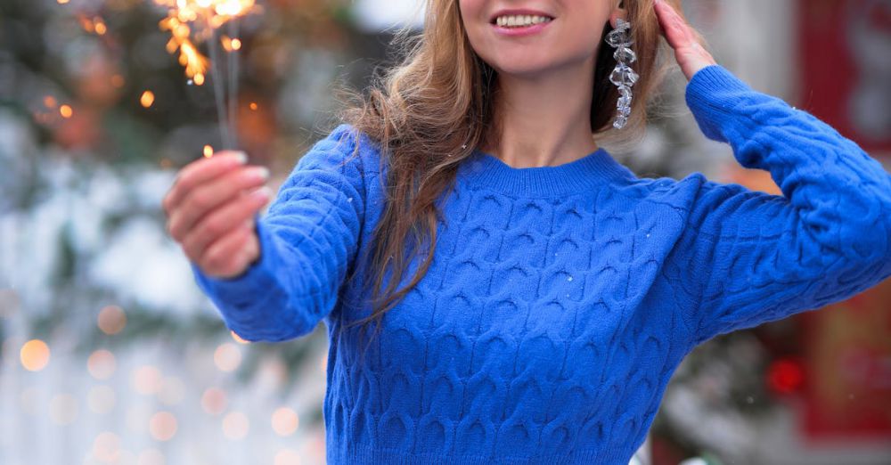 Fireworks Winter Festivals - Smiling woman enjoying a sparkler at an outdoor winter market, surrounded by holiday decorations.