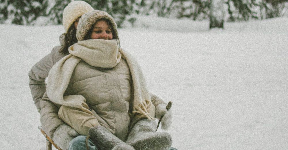 Snow Activity Festivals - Two women enjoying a playful sled ride in a snowy winter landscape.