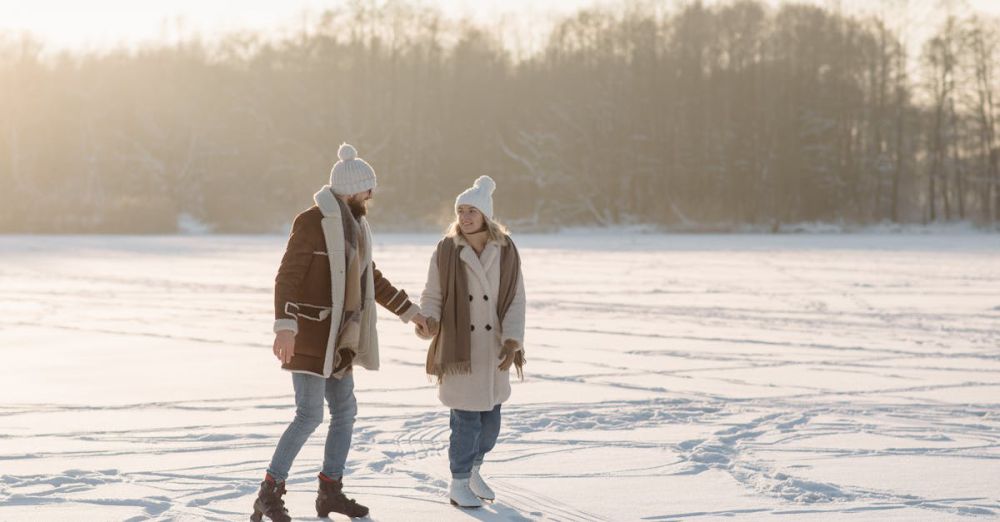 Winter Sports Festivals - Joyful couple holding hands while ice skating on a sunny winter day, surrounded by snow.