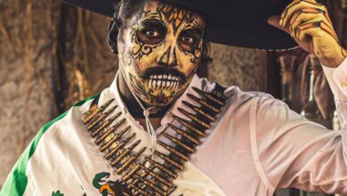 Cultural Traditions Festivals - Man with Catrina makeup and traditional Mexican attire for Day of the Dead celebration in Mexico City.