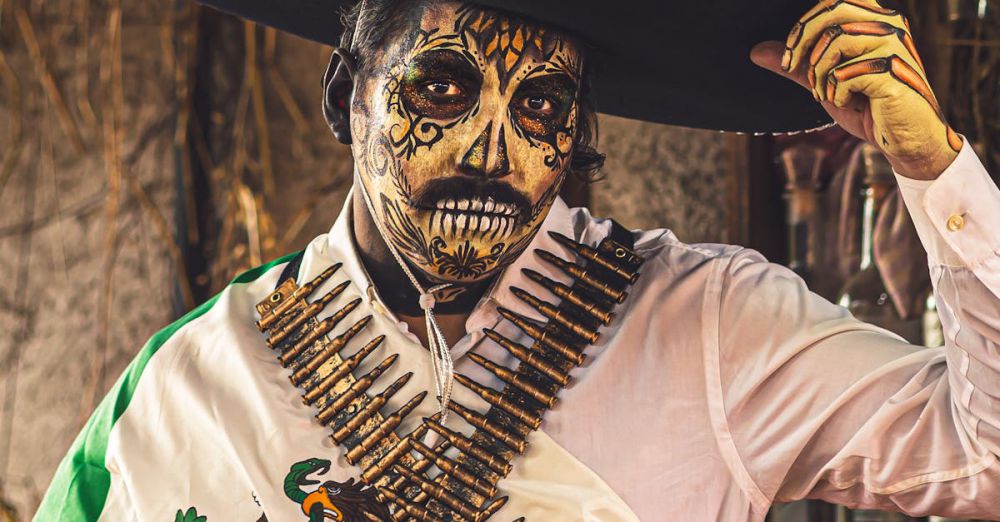 Cultural Traditions Festivals - Man with Catrina makeup and traditional Mexican attire for Day of the Dead celebration in Mexico City.