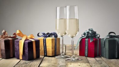 Gifts - Luxurious gifts with ribbons and champagne flutes on a wooden table, perfect for celebrations.