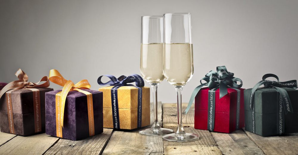 Gifts - Luxurious gifts with ribbons and champagne flutes on a wooden table, perfect for celebrations.