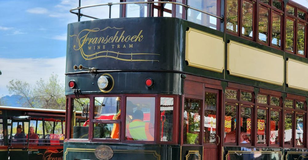 Cultural Scenic Train Rides - Charming two-storey tram at the popular Franschhoek wine tram station, perfect for travel and tourism.