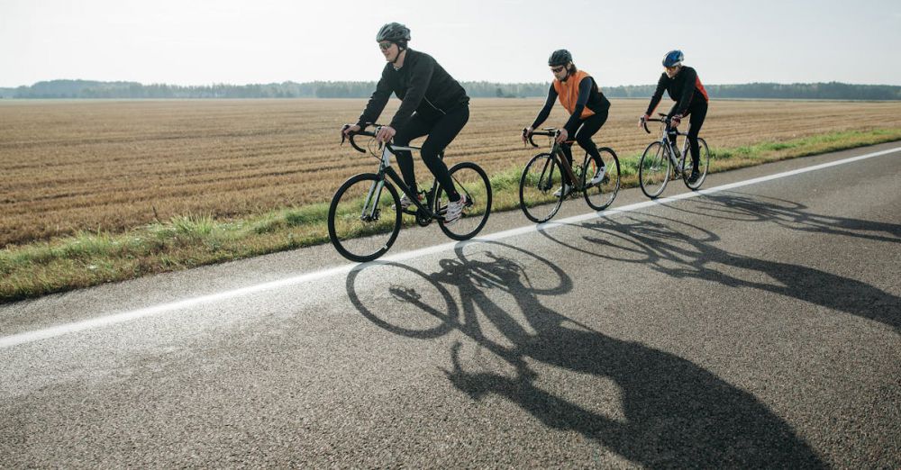 Group Scenic Train Rides - Three cyclists enjoy a leisurely ride on a rural road surrounded by fields