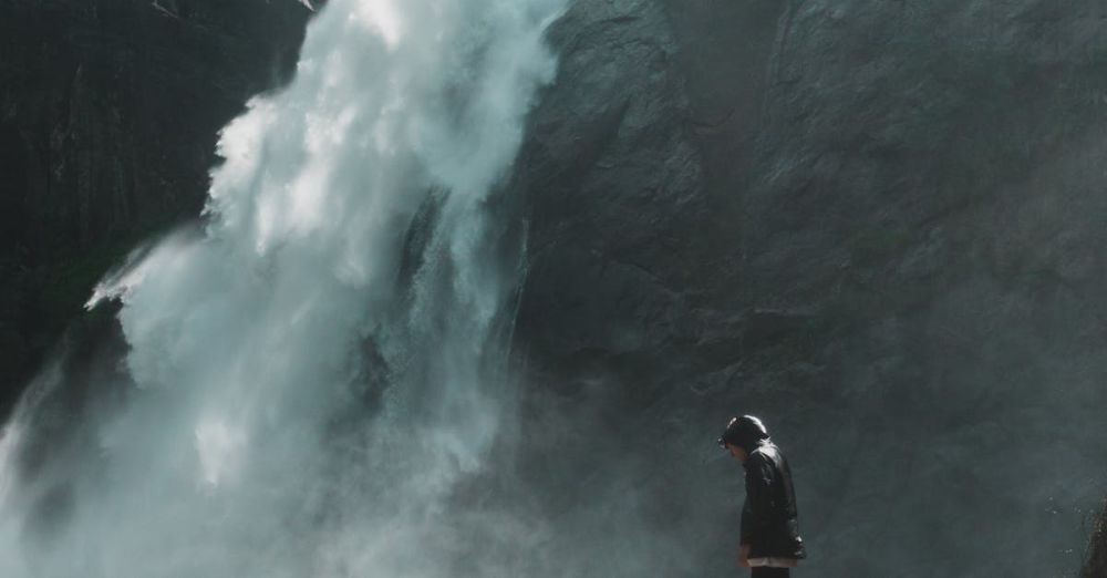 Rock Climbing Beginners - A man standing near a breathtaking waterfall in Badulla, Sri Lanka, showcasing nature's beauty and adventure.