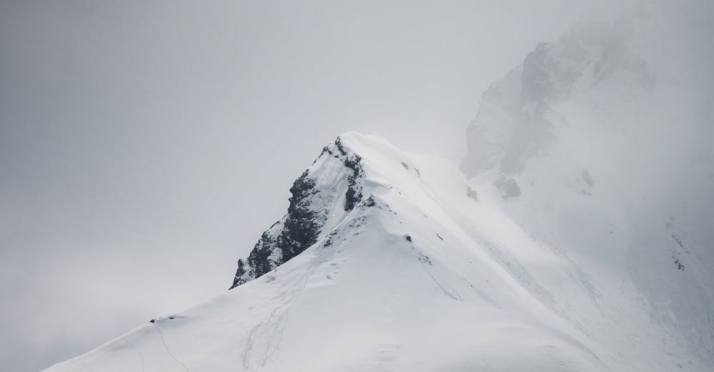 Ice Rock Climbing - Snowy mountain peak shrouded in mist, creating a mysterious winter scene in Hintertux, Austria.