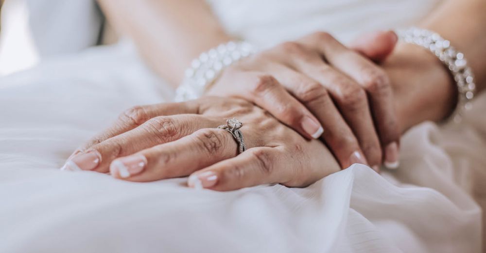 Jewelry - Close-up image of a bride's hands adorned with a wedding ring and jewelry, showcasing elegance.