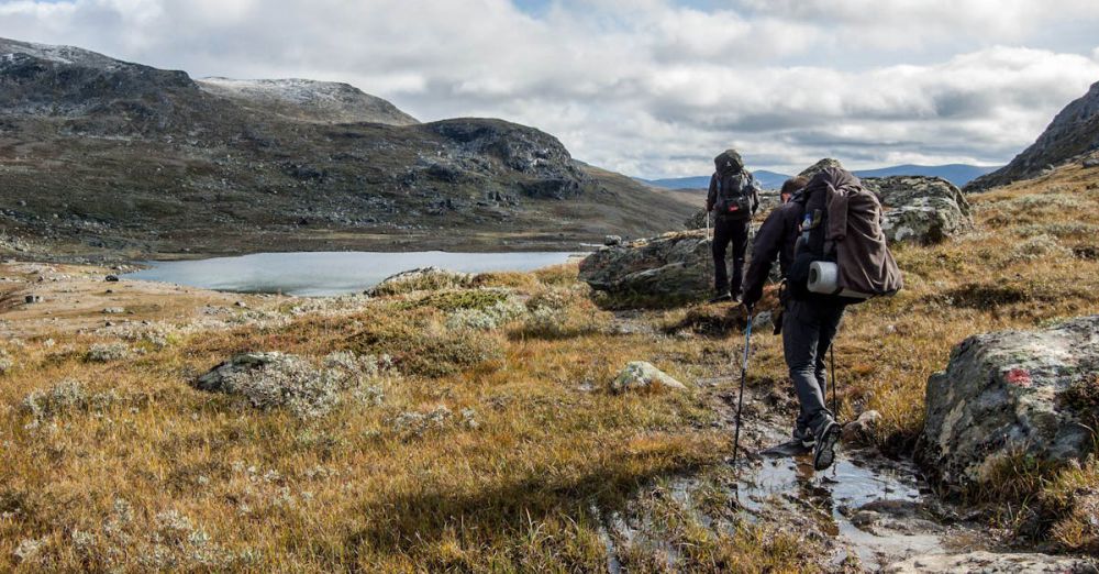 Adventure Rock Climbing - Adventurous hikers explore the scenic Vålådalen landscape in Sweden during fall.