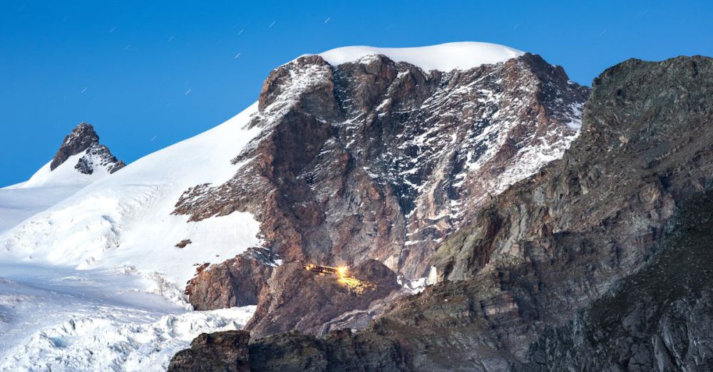 Night Rock Climbing - Breathtaking twilight scene of Monte Rosa with snow-covered peaks and clear night sky.