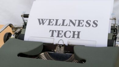 Fitness Trackers - A close-up of a vintage typewriter featuring a paper with the words 'Wellness Tech.'