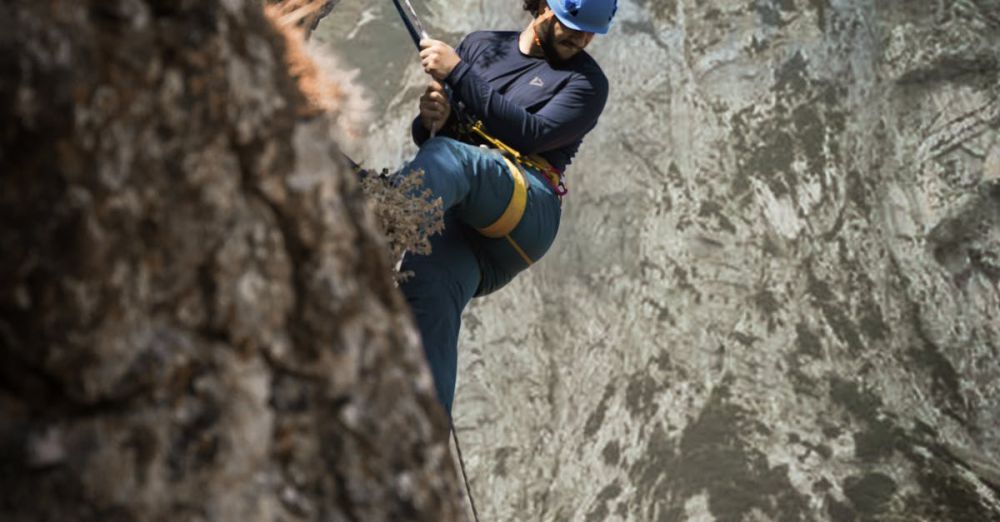 Technical Terrain Climbing - A daring climber ascends a rugged mountain face, showcasing adventure and skill.