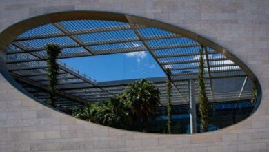 Urban Gardens - Futuristic building with lush greenery and a unique oval opening in Lisbon.