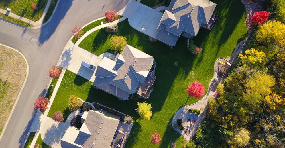 Community Urban Gardens - A picturesque aerial view showcasing suburban homes with vibrant gardens and tree-lined streets.