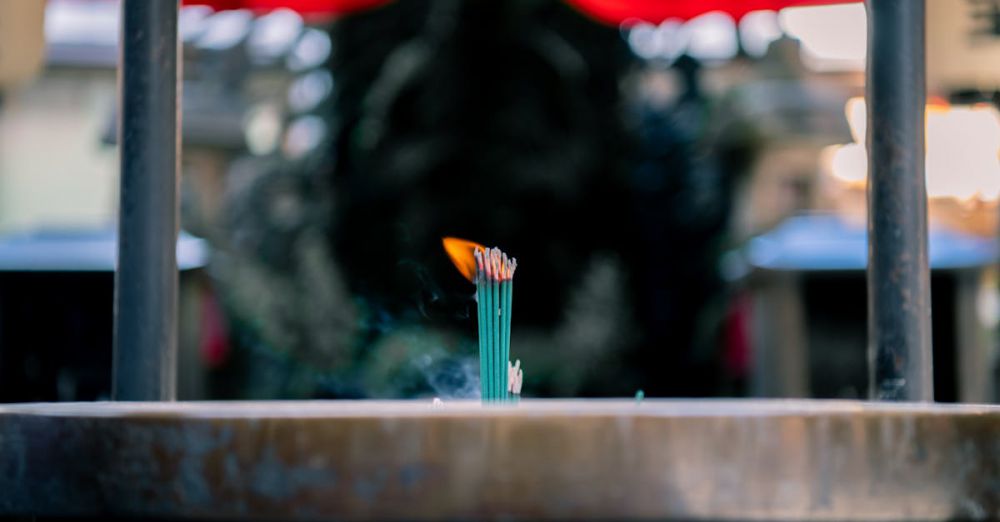 Aromatic Urban Gardens - Close-up of burning incense sticks at an Osaka shrine capturing the serene atmosphere.