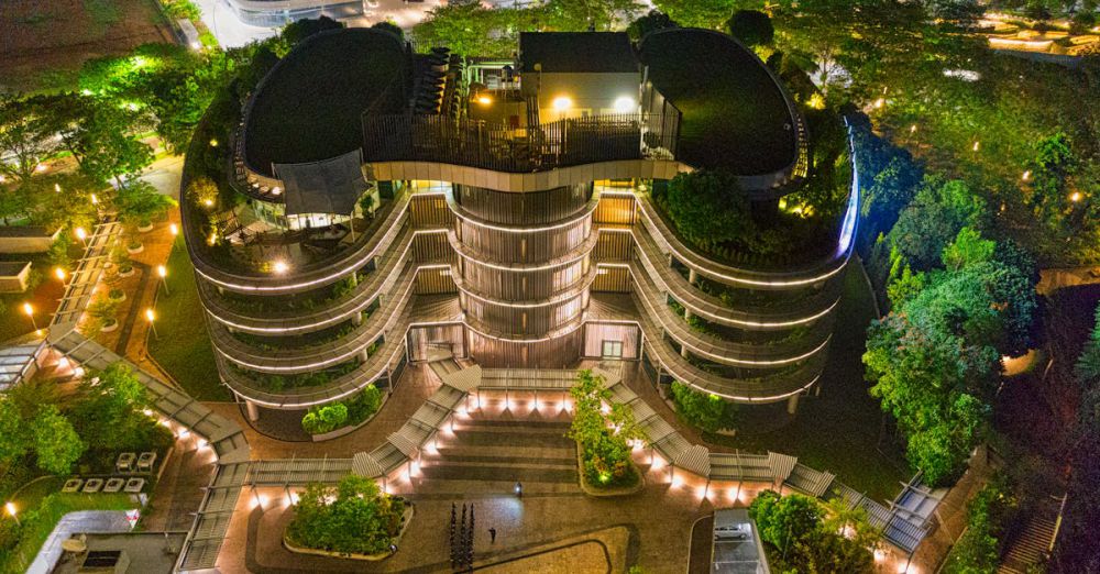 Rooftop Urban Gardens - A stunning night aerial view of a modern architectural building in Banten, Indonesia, illuminated with vibrant lights.