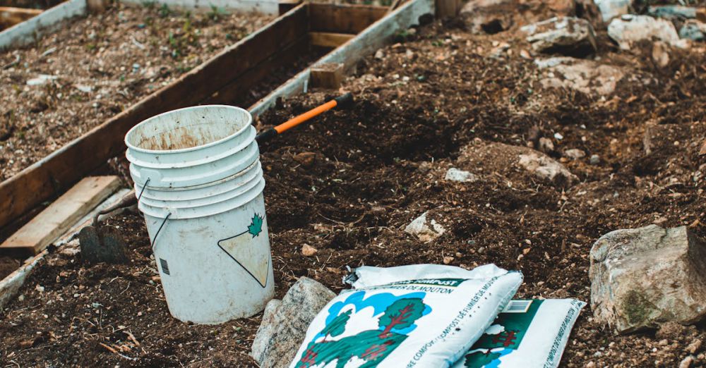 Sustainable Practices Gardens - White bucket and gardening supplies on soil, perfect for outdoor gardening themes.