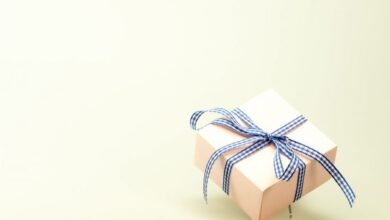 Gifts - Pink gift box with blue ribbon on a soft background, perfect for celebrations and branding.