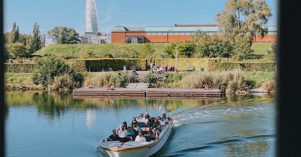 Garden Tour Urban Gardens - A tour boat cruises Malmö's canal with Turning Torso in the background.