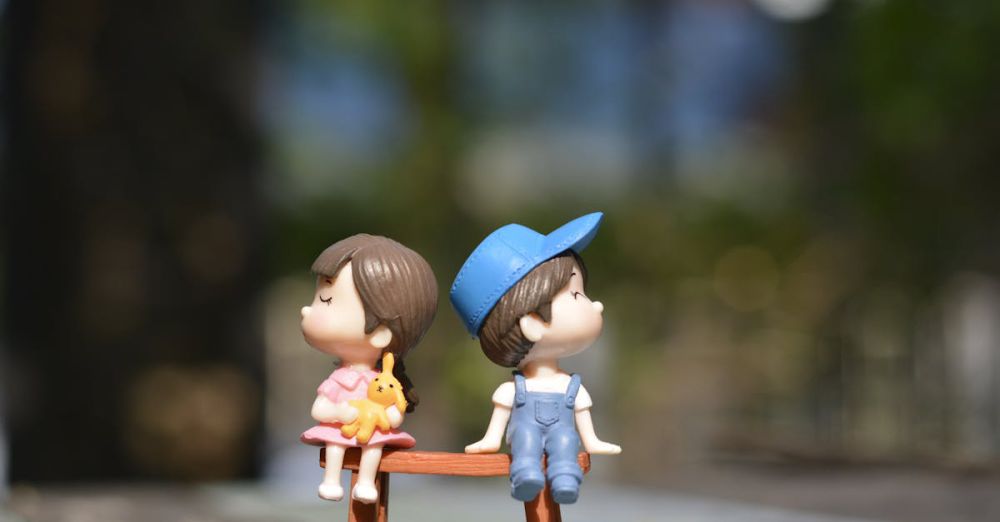 Toy - Adorable figurines of a boy and girl sit on a bench, bathed in summer sunlight.