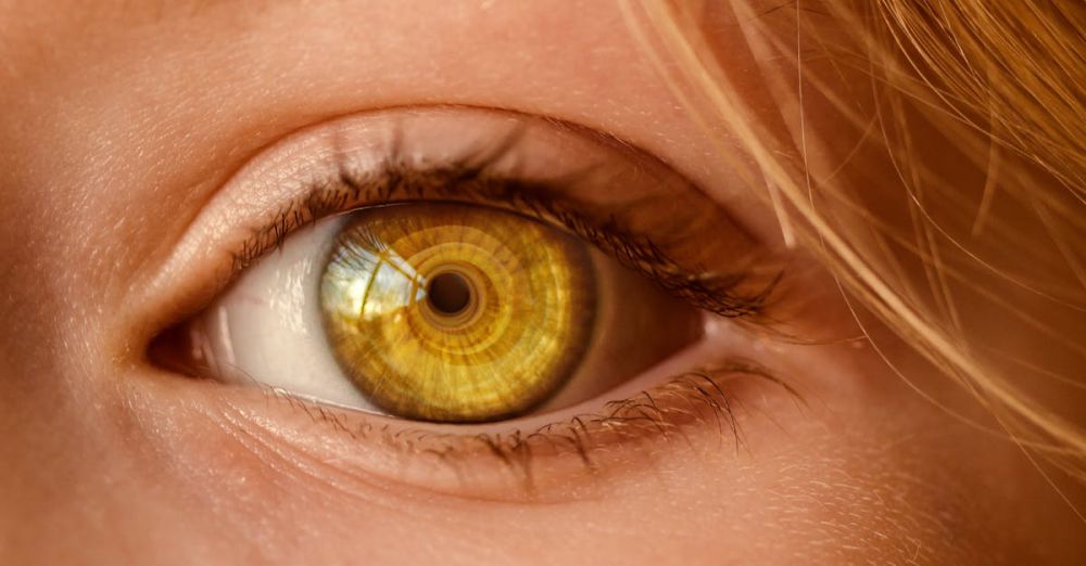 Centers - Detailed close-up of a human eye with a unique golden iris and spiral light reflection.