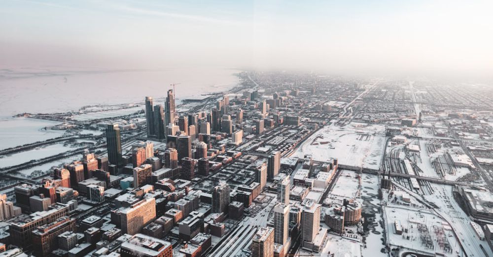 Neighborhoods - A breathtaking aerial view of Chicago's skyline covered in snow, showcasing the city's architecture during winter.