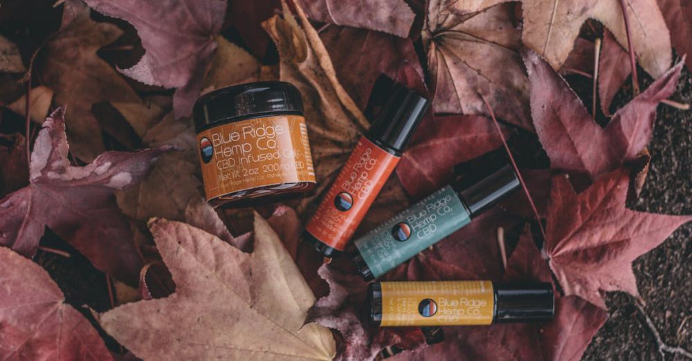 Products - CBD products nestled among autumn leaves, showcasing natural skincare options in a fall setting.