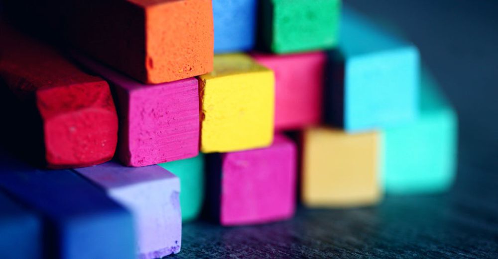 Supplies - Close-up of stacked colorful pastel chalks, showcasing a vibrant array of colors and textures.