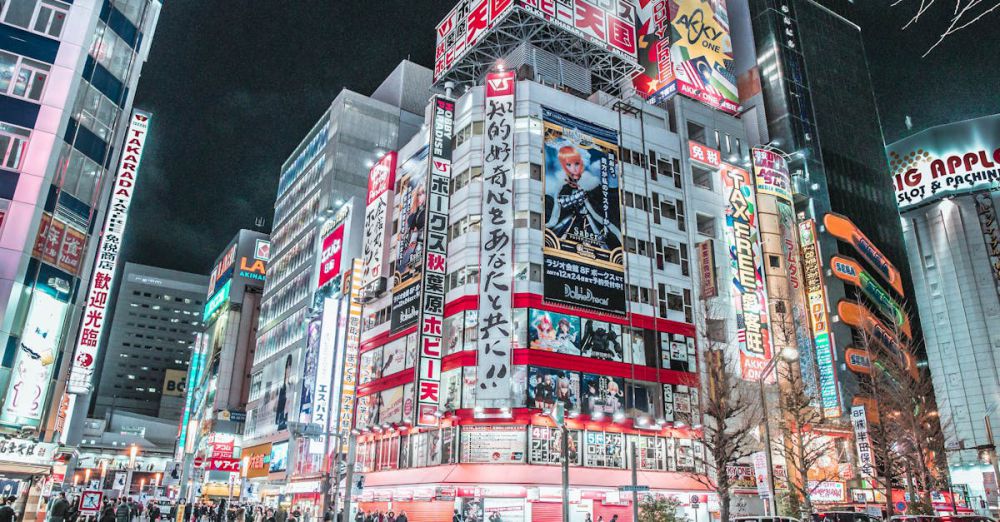 Districts - Explore the vibrant cityscape of Shinjuku, Tokyo at night with bright neon lights and bustling streets.