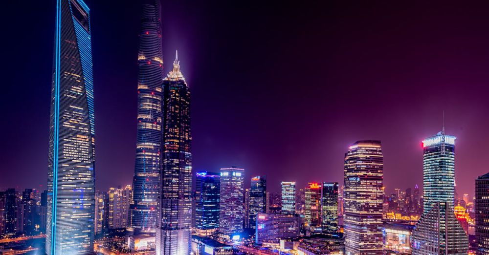 Cities - Majestic view of Shanghai's illuminated skyline featuring iconic skyscrapers at night.