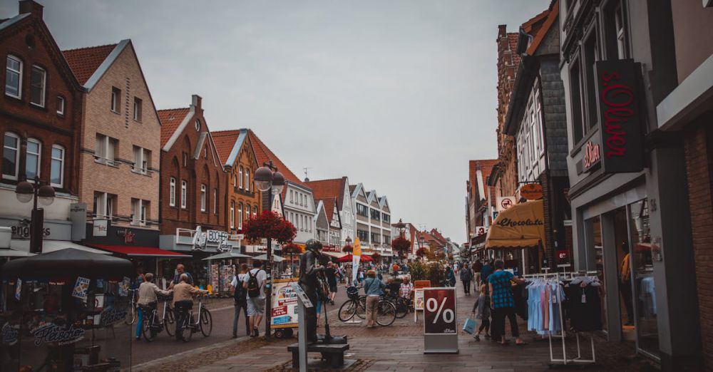 Shops - A bustling urban street with shops, people, and bicycles in a lively marketplace atmosphere.