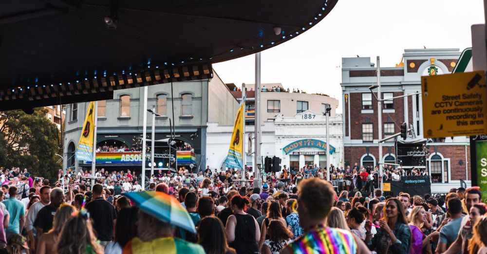 Performances - A lively and colorful LGBTQ+ parade on Sydney's Oxford Street with a festive crowd.