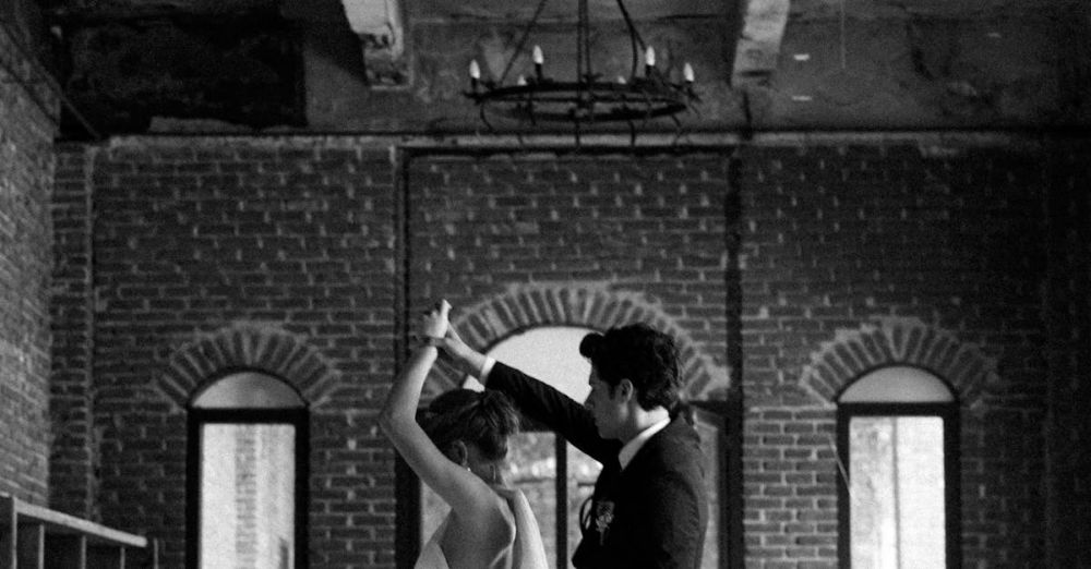 Venues - A couple dances gracefully in a rustic venue, capturing a timeless wedding moment.