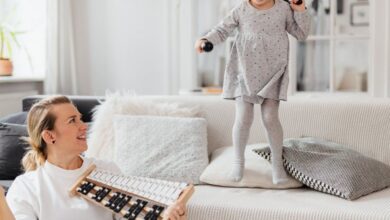Plays - Fun indoor scene of a mother and daughter playing with a xylophone, creating joyful memories.