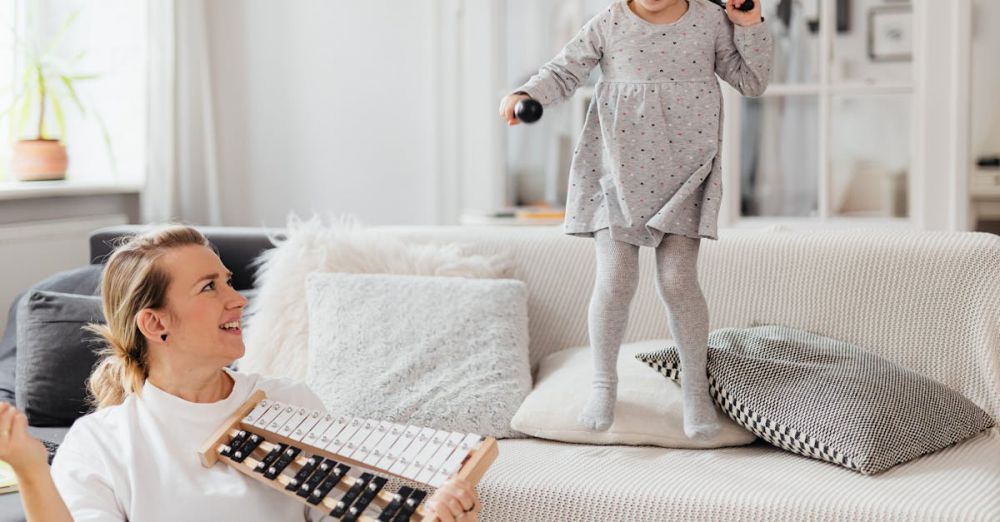 Plays - Fun indoor scene of a mother and daughter playing with a xylophone, creating joyful memories.