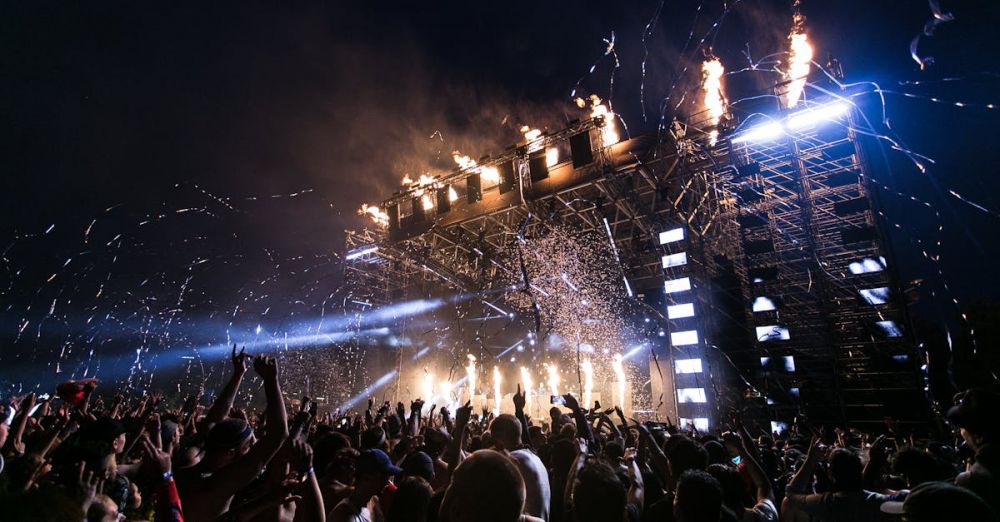 Festivals - Vibrant concert scene with crowd enjoying night festival and dynamic stage fireworks.