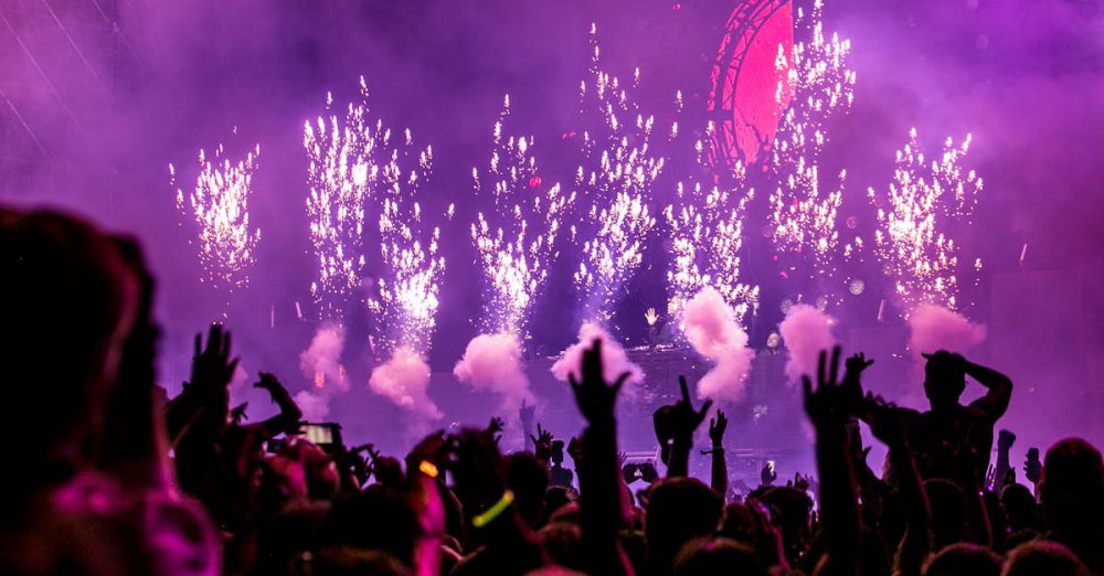 Festival - Vibrant EDM concert scene with fireworks, smoke, and enthusiastic crowd enjoying the music.