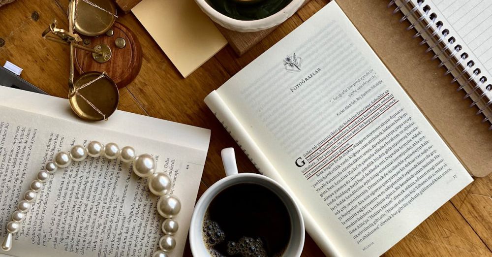 Productions - A warm flat lay featuring books, candle, coffee, and pearl necklace for a cozy vibe.