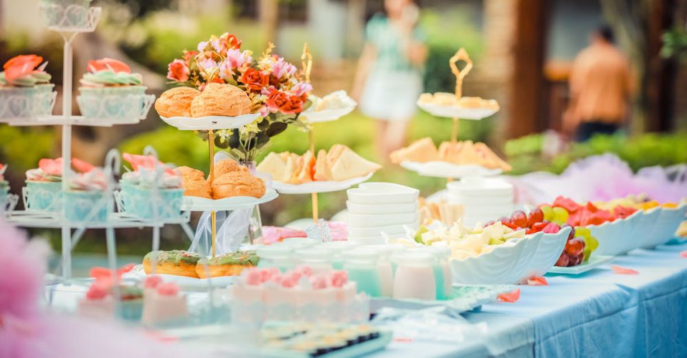 Events - A vibrant outdoor buffet table showcasing an array of colorful pastries and fruits, perfect for parties.