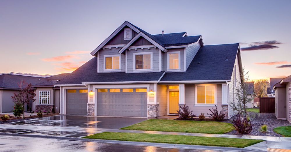 House - Elegant suburban home with driveway at sunset showcasing modern architecture.